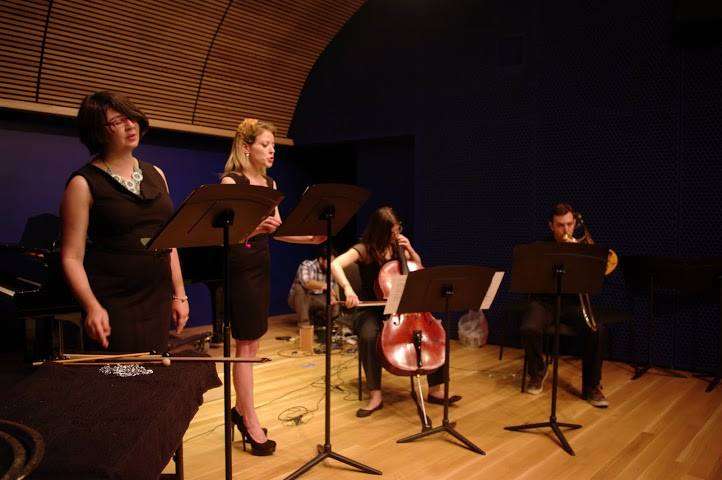 Jamie singing on stage at the National Opera Center with soprano Pamela Stein Lynde and two string players.