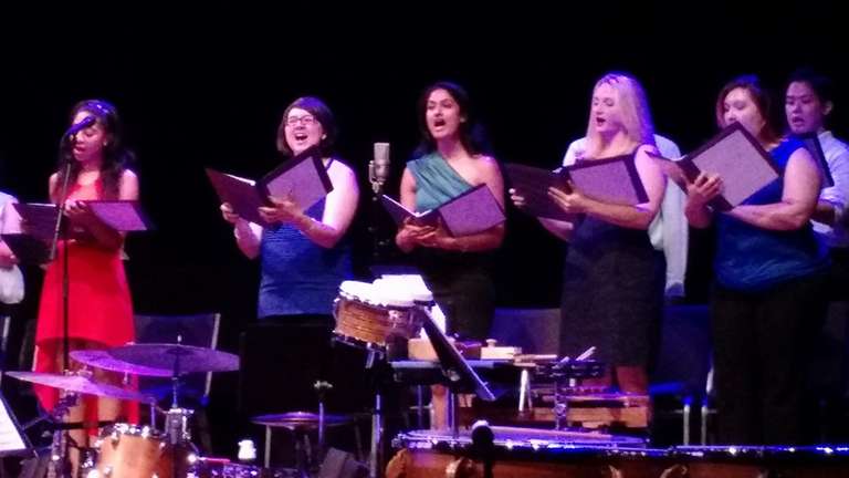 Jamie sings on stage with other choristers.