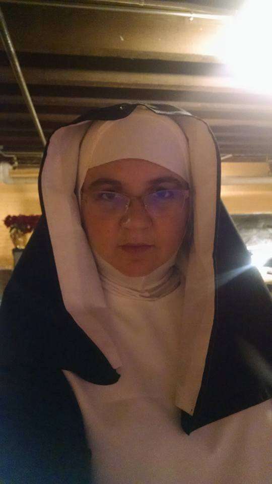 Jamie wears a nun costume for her performance in Suor Angelica, looking intensely at the camera.