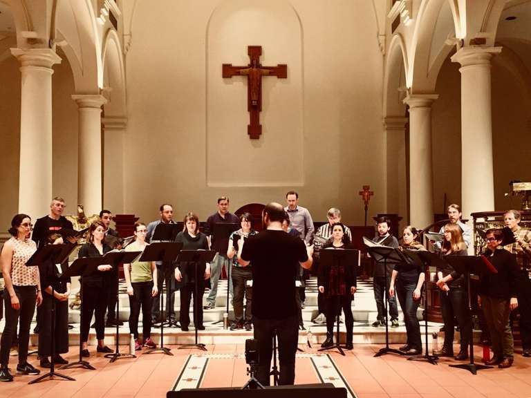A performance at a church with C4, with the conductor in the middle of the frame.